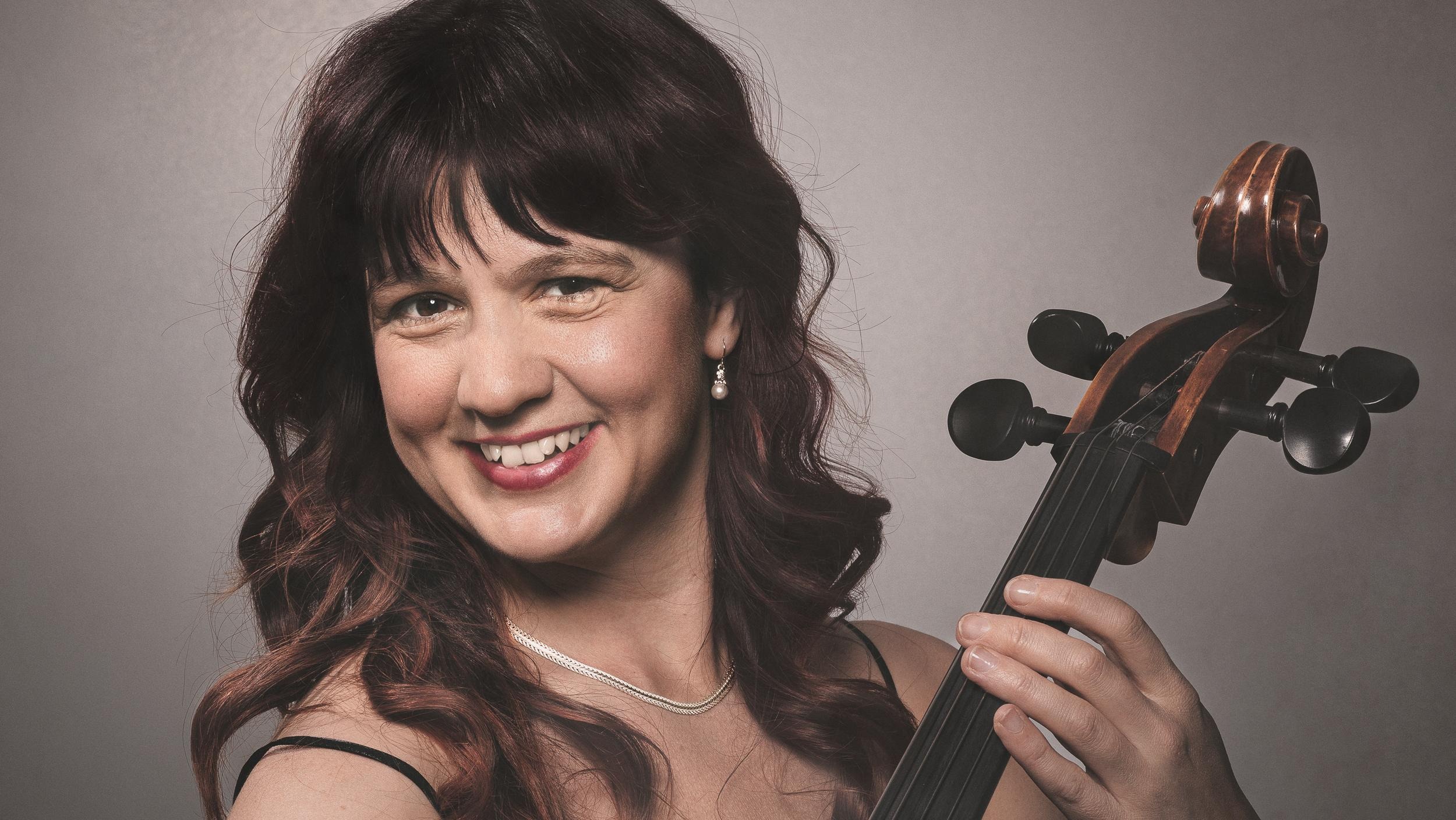 Cellisten sitter med en cello framför sig