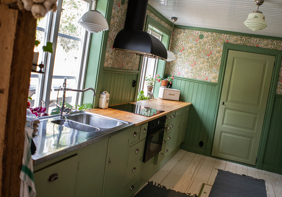 Ett kök i gammaldags stil och grönt tema.