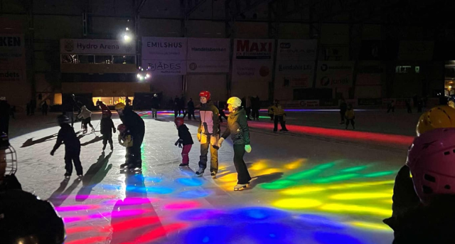 Isdisco, barn åker skridskor i discoljus.